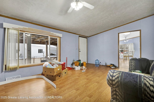 1987 W Isabella Rd, Midland, MI 48640 - interior space featuring hardwood / wood-style flooring, ceiling fan, crown molding, and a textured ceiling