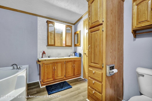 1987 W Isabella Rd, Midland, MI 48640 - bathroom with hardwood / wood-style flooring, a textured ceiling, toilet, and a bathing tub