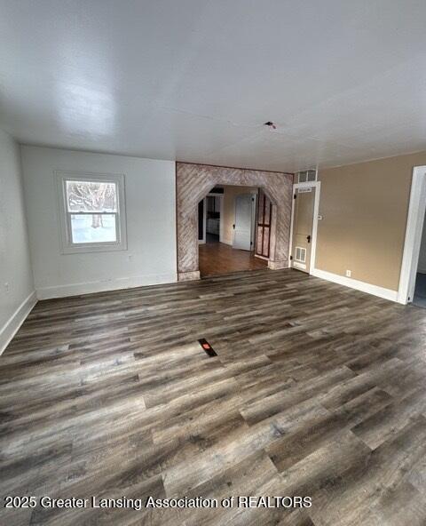 unfurnished living room featuring dark hardwood / wood-style flooring