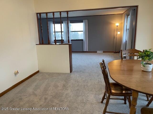 carpeted dining room featuring visible vents and baseboards