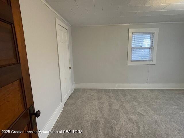 carpeted spare room with baseboards