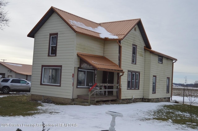 view of front of home featuring covered porch and metal roof