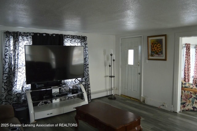 living room with a baseboard heating unit, hardwood / wood-style floors, and a textured ceiling