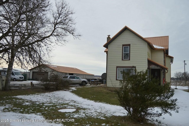 view of snow covered exterior with a garage