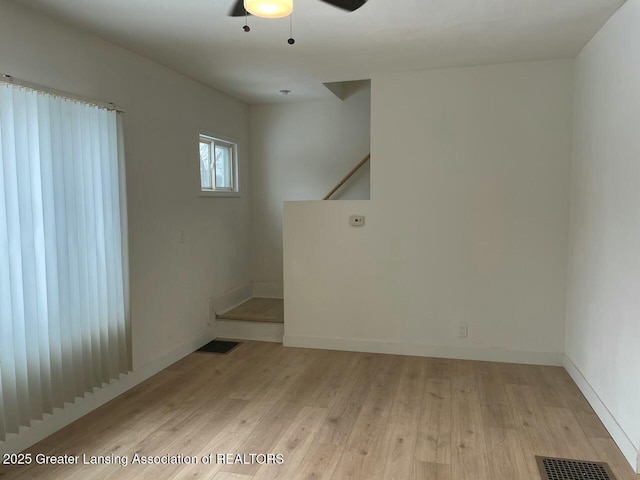 empty room featuring ceiling fan and light wood-type flooring