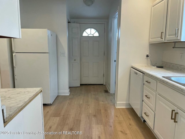 kitchen featuring white cabinetry, white appliances, and light hardwood / wood-style floors