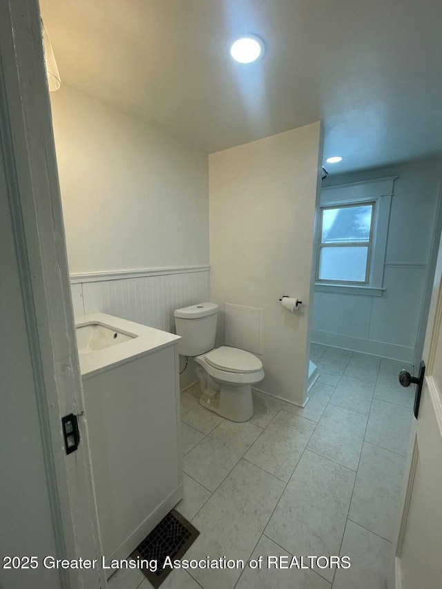 bathroom featuring vanity and toilet