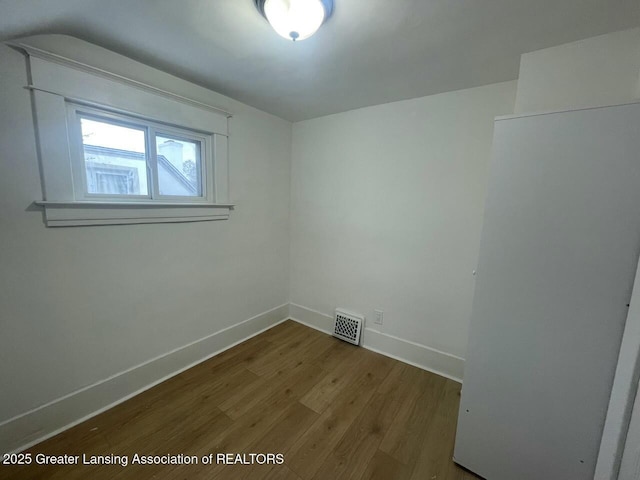 empty room with hardwood / wood-style floors