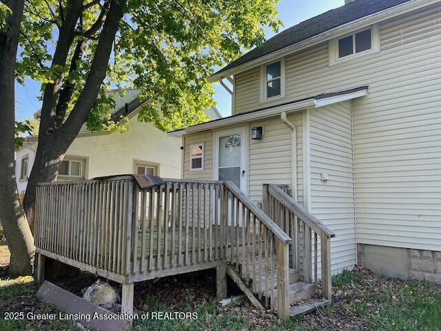 rear view of property featuring a deck