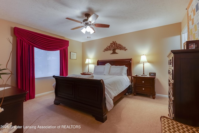 carpeted bedroom with ceiling fan and a textured ceiling