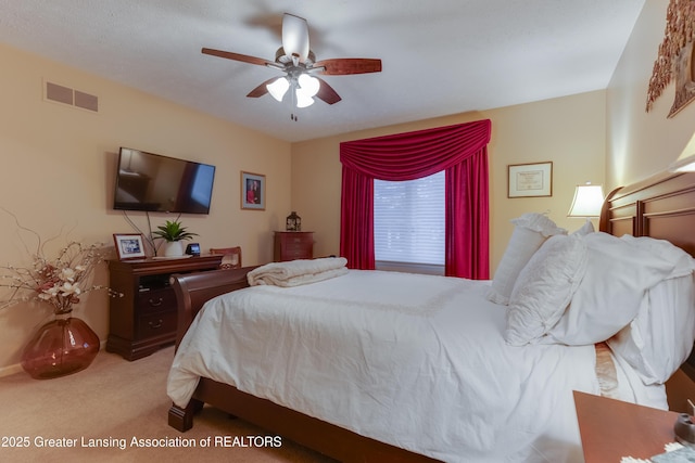 bedroom with light carpet and ceiling fan