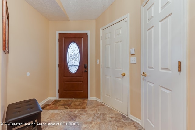 entryway with a textured ceiling