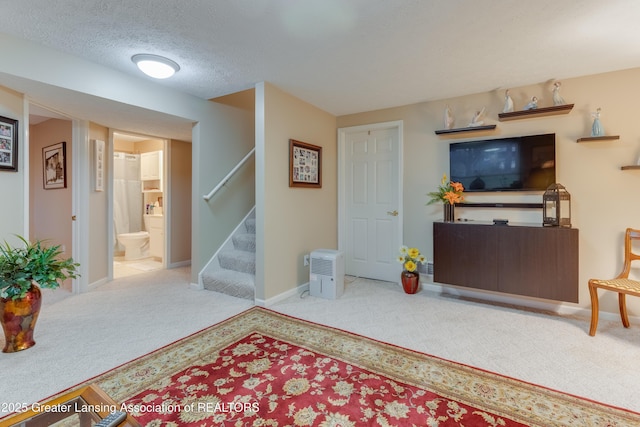 living room featuring light colored carpet and a textured ceiling