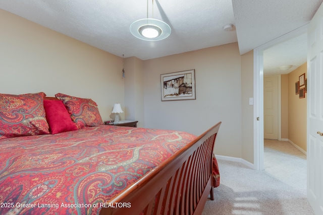 bedroom with carpet floors and a textured ceiling