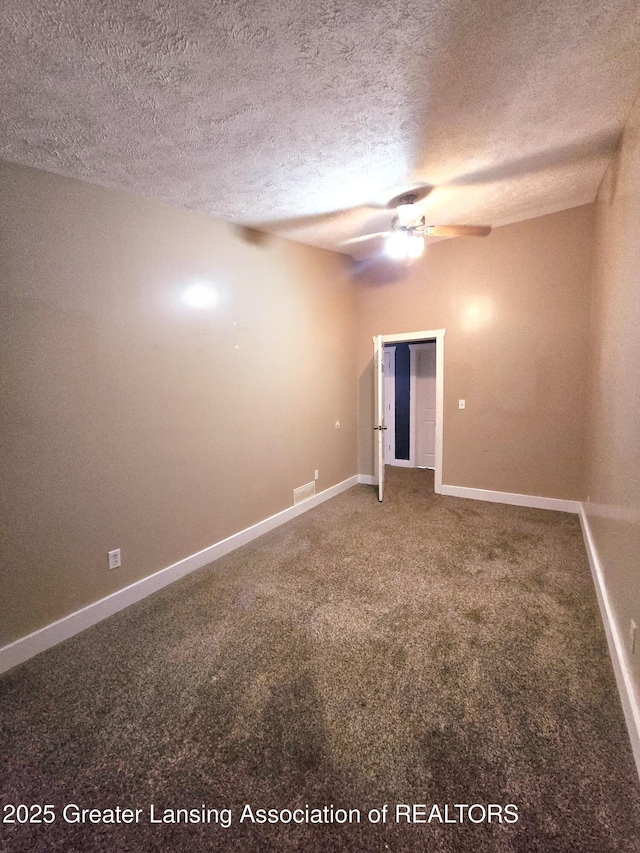 spare room featuring carpet, a textured ceiling, and ceiling fan