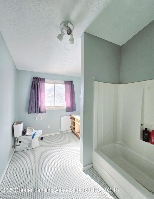 bathroom with plus walk in shower, tile patterned floors, and a textured ceiling