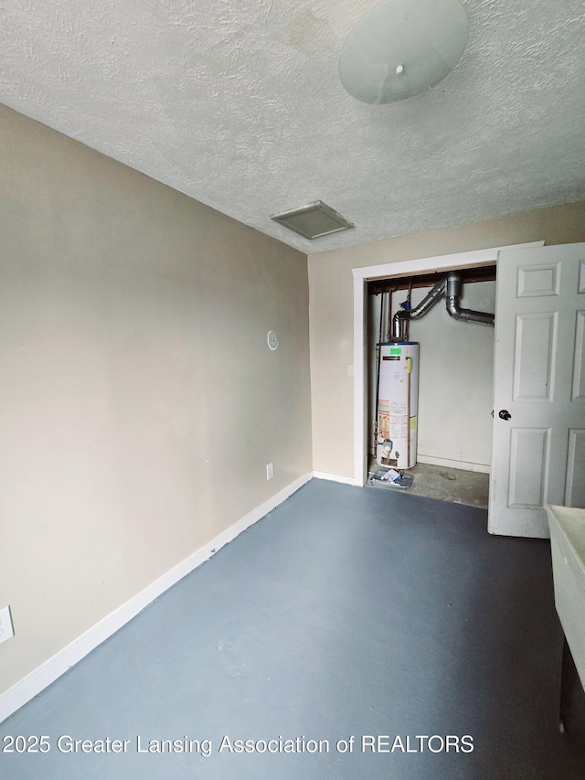 basement with a textured ceiling and gas water heater