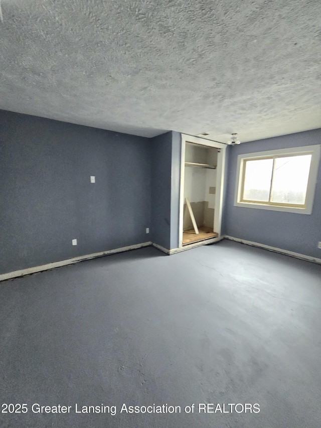 unfurnished bedroom featuring a closet and a textured ceiling