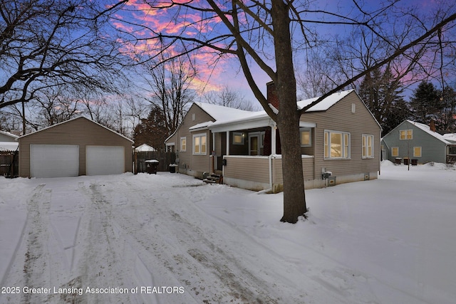 view of front of home featuring covered porch, a detached garage, and an outdoor structure