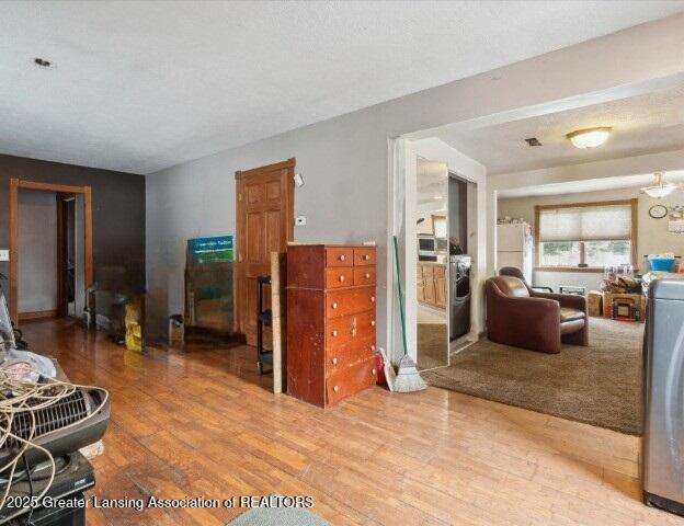 living room with an inviting chandelier and wood-type flooring