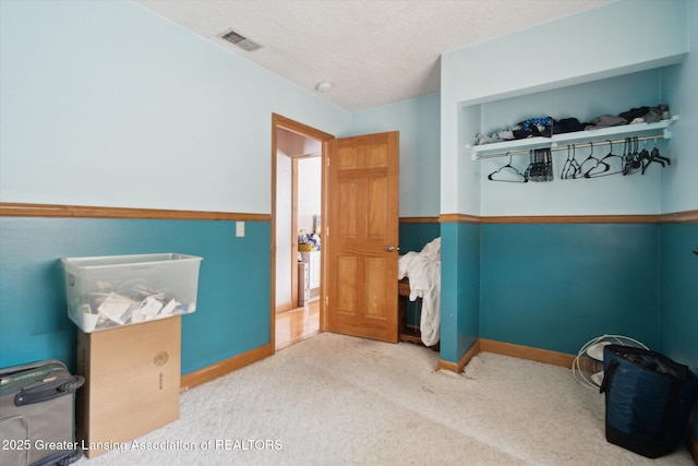 bedroom featuring carpet and a textured ceiling