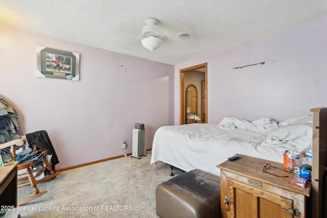 carpeted bedroom featuring a textured ceiling