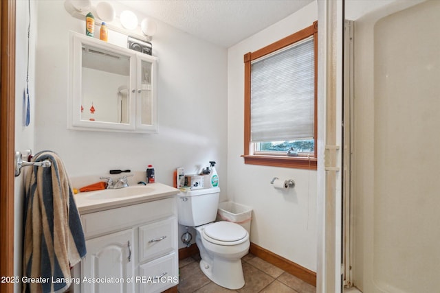 bathroom with vanity, tile patterned floors, a textured ceiling, and toilet