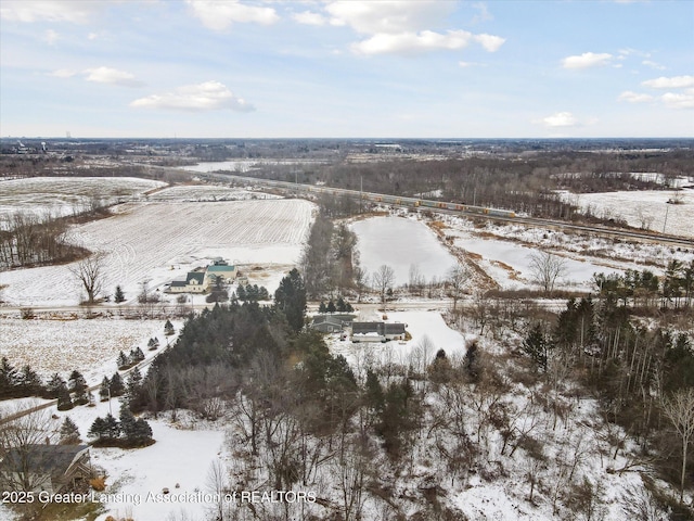 snowy aerial view featuring a rural view