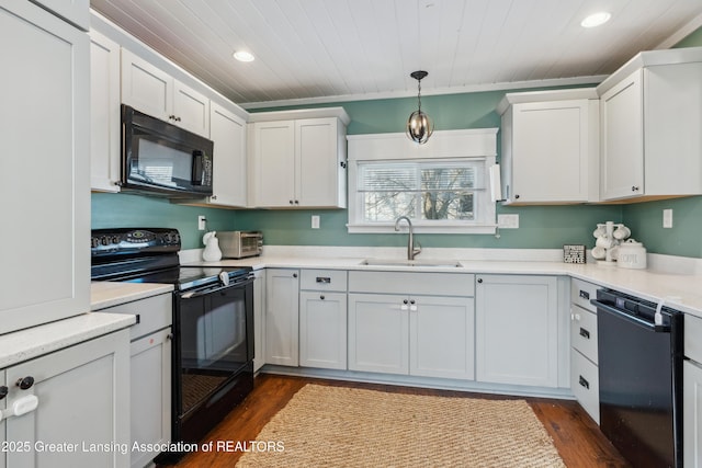 kitchen with sink, decorative light fixtures, black appliances, and white cabinets