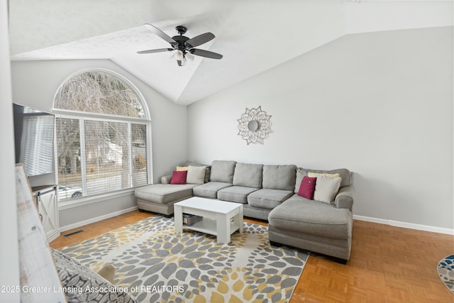 living room with a wealth of natural light, parquet flooring, and vaulted ceiling