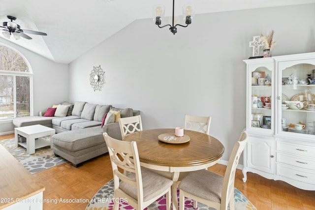 dining area featuring light parquet floors, vaulted ceiling, and ceiling fan