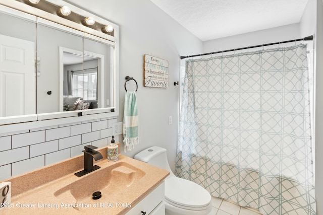 bathroom with tasteful backsplash, vanity, curtained shower, and toilet