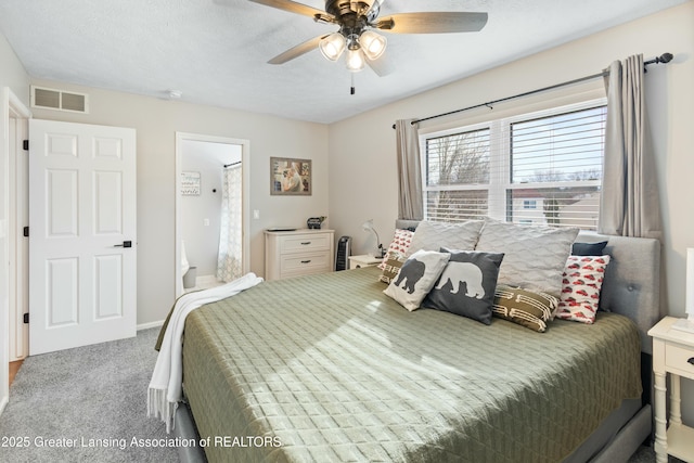 bedroom featuring ceiling fan, a textured ceiling, and carpet flooring