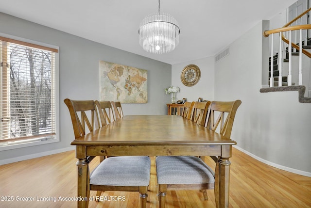 dining room featuring an inviting chandelier and hardwood / wood-style floors