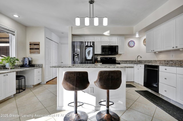 kitchen featuring pendant lighting, black dishwasher, a kitchen breakfast bar, stainless steel fridge with ice dispenser, and light stone countertops