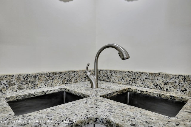 room details with light stone counters and sink