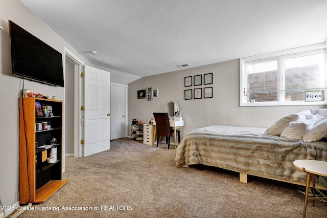 bedroom featuring lofted ceiling and carpet