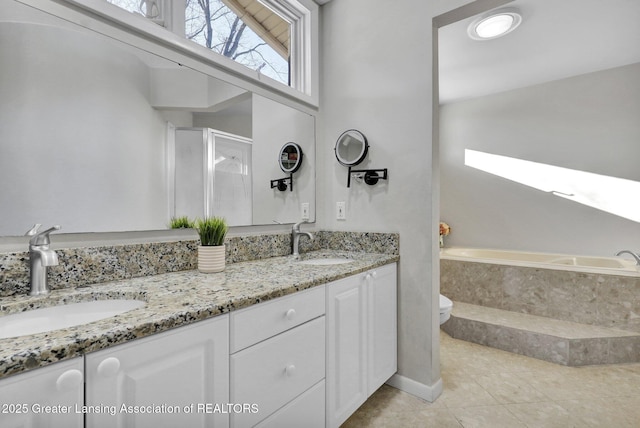 full bathroom with toilet, tile patterned floors, shower with separate bathtub, and vanity