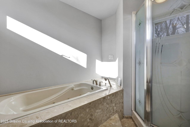 bathroom featuring independent shower and bath