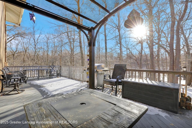 snow covered deck featuring a pergola