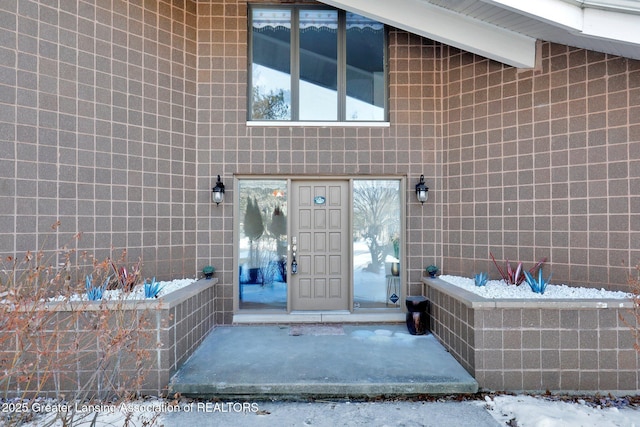 view of snow covered property entrance