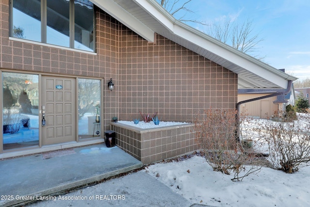 view of snow covered property entrance