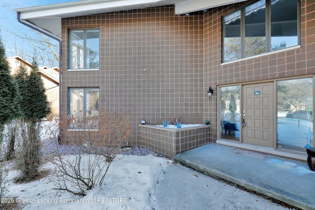 view of snow covered property entrance