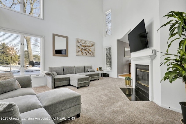 carpeted living room featuring a high ceiling