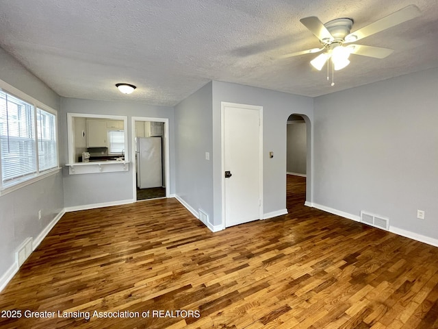 spare room featuring ceiling fan, hardwood / wood-style flooring, and a textured ceiling