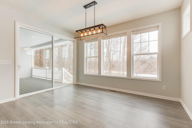 unfurnished dining area with hardwood / wood-style floors