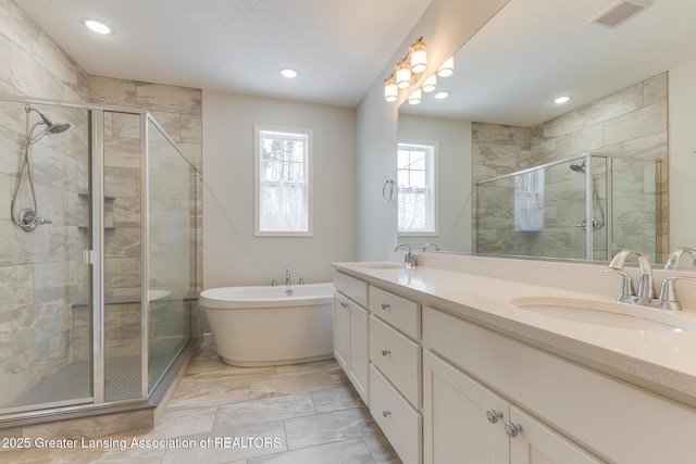 bathroom with vanity and independent shower and bath