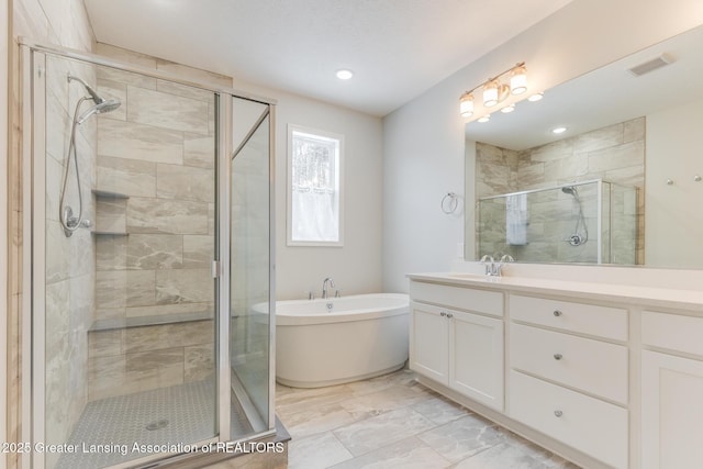 bathroom featuring vanity and shower with separate bathtub