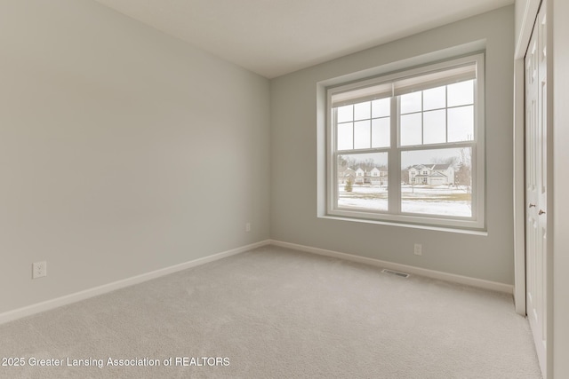 empty room featuring light colored carpet