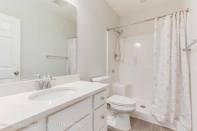 bathroom featuring vanity, a shower with curtain, toilet, and hardwood / wood-style flooring